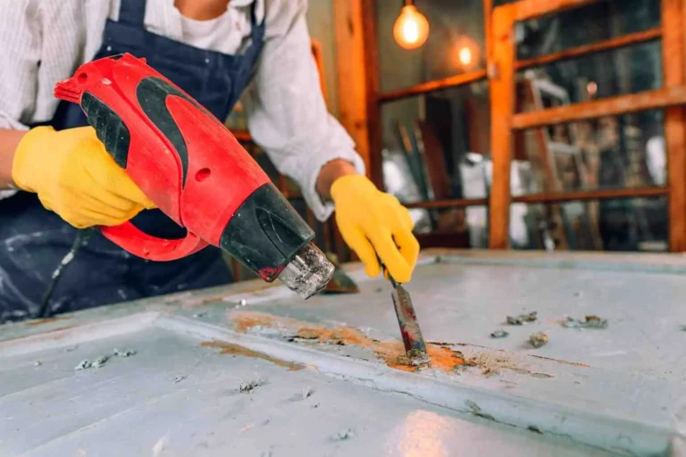 How to Remove Paint from Metal using a heat gun and paint scraper tool on a metal surface