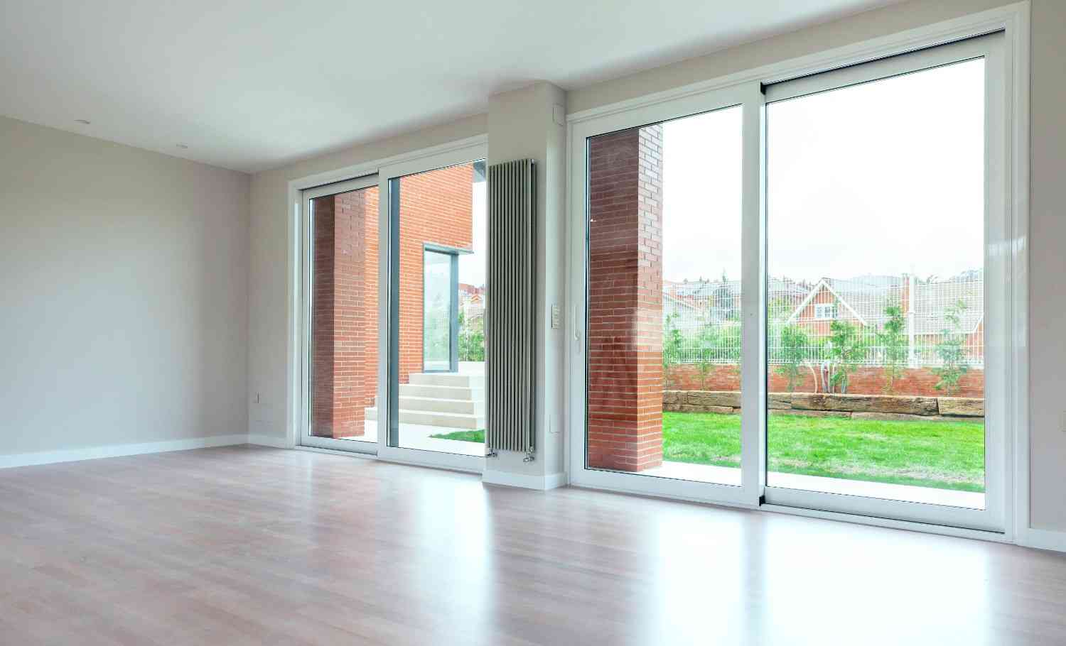 Standard Sliding Glass Door Size showing wide sliding glass patio doors installed in a modern living room with outdoor view access