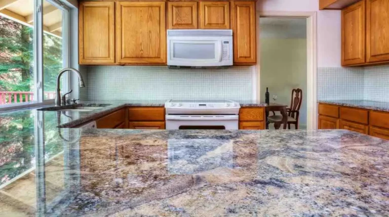 Countertop Installation Cost: Polished granite countertop with blue and beige veining installed in a kitchen with oak cabinets and tile backsplash, showing countertop installation cost quality