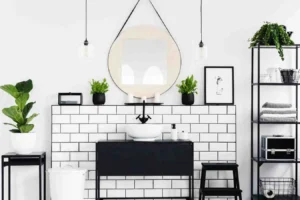 How to Create a Minimalist Bathroom with white subway tiles, black vanity, round mirror, open shelving, indoor plants, and a clean clutter-free design.