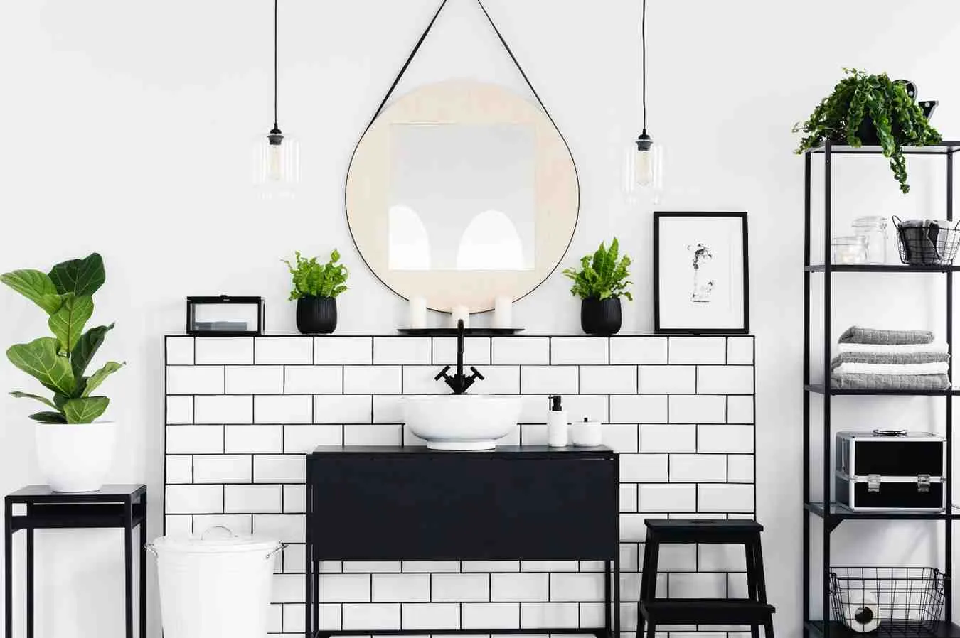 How to Create a Minimalist Bathroom with white subway tiles, black vanity, round mirror, open shelving, indoor plants, and a clean clutter-free design.