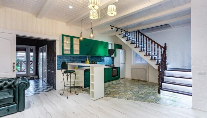 grodno-belarus-august-2019-luxure-hall-interior-loft-flat-grey-style-design-with-green-kitchen-fireplace-chester-sofa-with-stairs_97694-5248