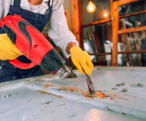How to Remove Paint from Metal using a heat gun and paint scraper tool on a metal surface