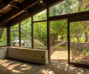Room Addition San Diego with large glass windows, natural light, and outdoor garden view creating a modern living space