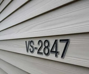 Vinyl siding Identification Numbers VS-2847 stamped on exterior wall panel for siding identification and matching